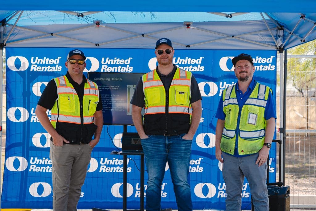 Three certified United Rentals trainers standing in front of a United Rentals backdrop at a safety demonstration event hosted with GCON during Safety Week 2025.